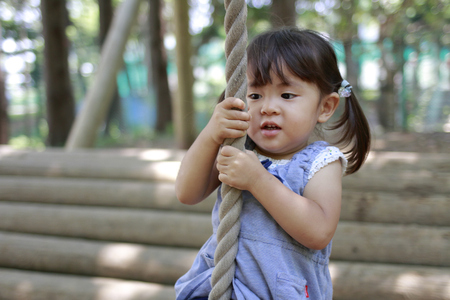 Japanese girl playing with flying fox (2 years old)の写真素材
