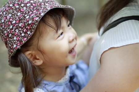 Japanese girl carried in her mother's back (2 years old)の写真素材