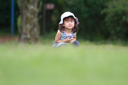 Japanese girl crying on the grass (2 years old)の写真素材