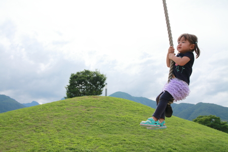 Japanese girl playing with flying fox (2 years old)の写真素材