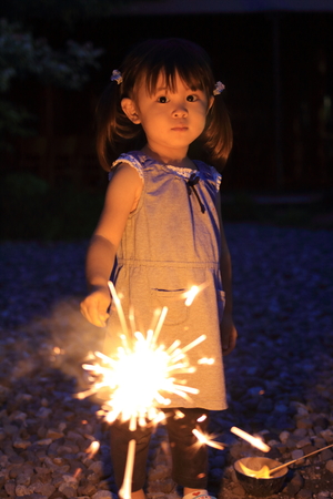 Japanese girl doing handheld fireworks (2 years old)の写真素材