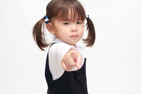 Japanese girl pointing at the camera in formal wear (2 years old)の写真素材