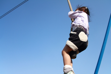 Japanese girl (3 years old) playing with flying foxの写真素材