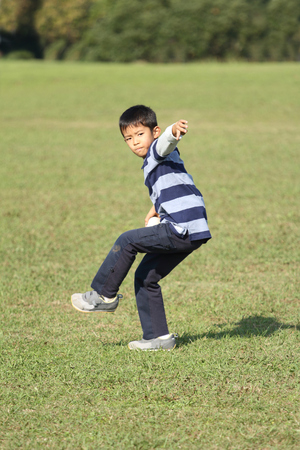 Japanese boy playing catch (second grade at elementary school)の写真素材