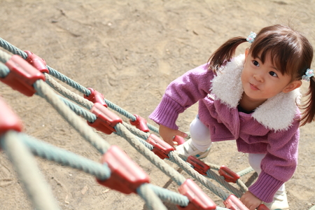 Japanese girl playing with rope walking (3 years old)の写真素材