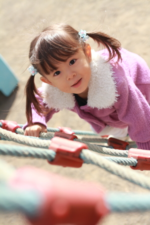 Japanese girl playing with rope walking (3 years old)の写真素材