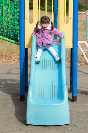 Japanese girl on the slide (3 years old)の写真素材