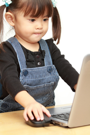Japanese girl using notebook PC (3 years old)の写真素材