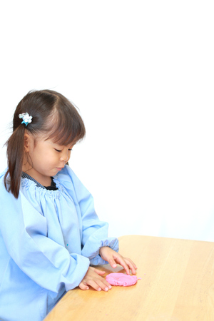 Japanese girl playing with clay (3 years old)の写真素材
