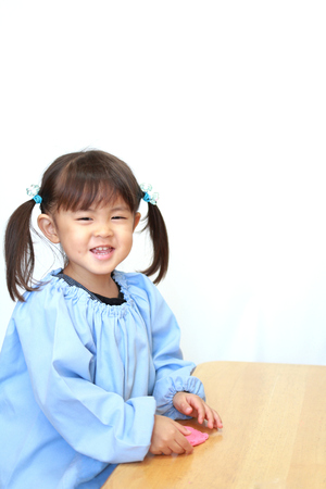 Japanese girl playing with clay (3 years old)の写真素材