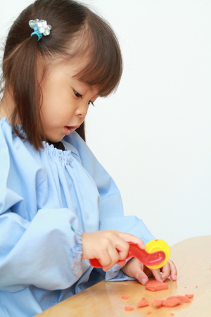 Japanese girl playing with clay (3 years old)の写真素材