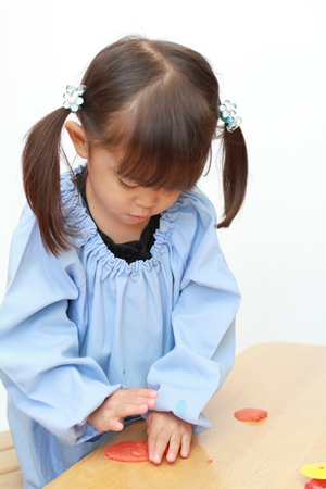 Japanese girl playing with clay (3 years old)の写真素材