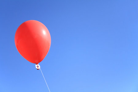 red balloon under the blue skyの写真素材