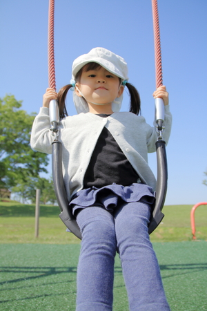 Japanese girl on the swing (3 years old)の写真素材