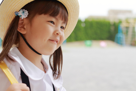 Japanese girl in uniform in kindergarten yard in summer (3 years old)の写真素材