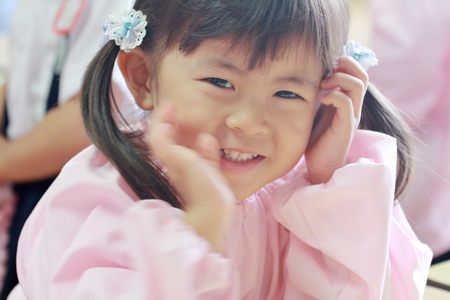 Japanese girl in playwear in her classroom (3 years old) (white back)の写真素材