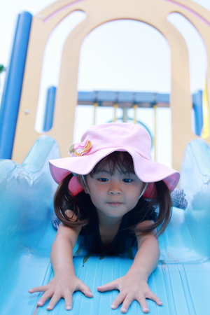 Japanese girl on the slide (3 years old)の写真素材