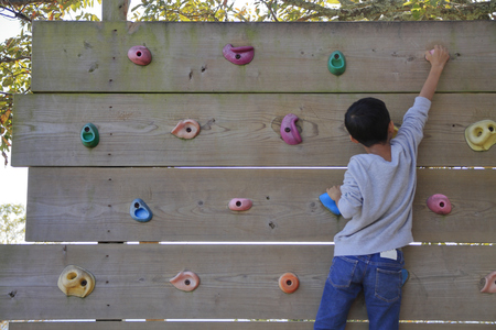 Japanese boy playing with bouldering (third grade at elementary school)の写真素材