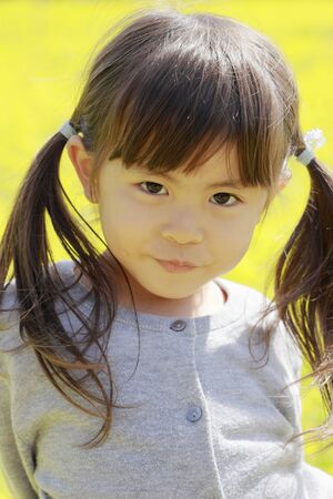 Japanese girl and field mustard (4 years old)の写真素材