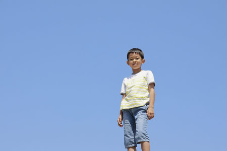 Japanese boy under the blue sky (fourth grade at elementary school)