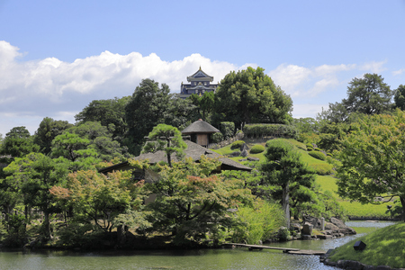 Okayama castle and Yuishinzan hill in Koraku garden in Okayama, Japanのeditorial素材