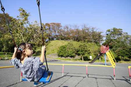 Japanese girl on the swingã(appearance from behind) (5 years old)の写真素材