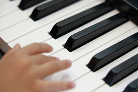 hands of Japanese girl playing a piano (4 years old)の写真素材