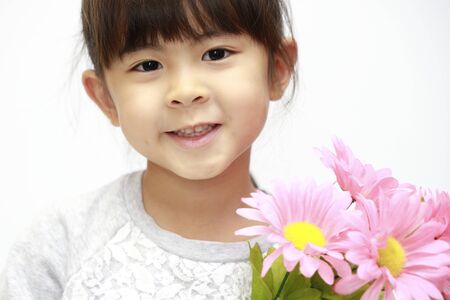 Japanese girl with flowers (white back) (5 years old)の写真素材