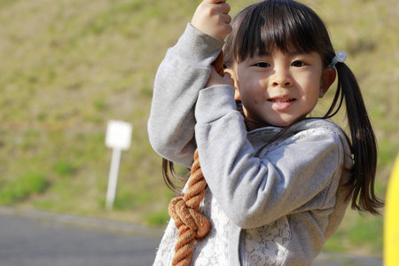 Japanese girl (5 years old) playing with flying fox