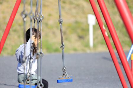 Japanese girl on the swing (5 years old)の写真素材