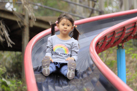 Japanese girl on the slide (5 years old)の写真素材