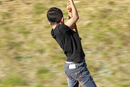 Japanese boy playing with flying fox (fourth grade at elementary school)の写真素材