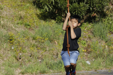 Japanese boy playing with flying fox (fourth grade at elementary school)