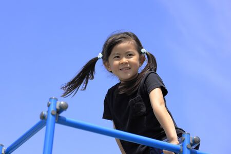 Japanese girl on the jungle gym (5 years old)の写真素材