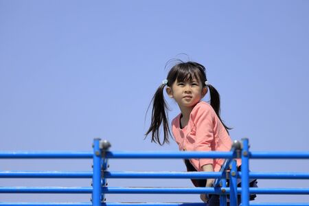 Japanese girl on the jungle gym (5 years old)の写真素材