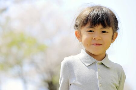 Japanese girl and cherry blossoms (5 years old)の写真素材