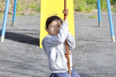 Japanese girl (5 years old) playing with flying foxの写真素材
