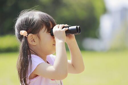 Japanese girl with opera glass in the green (5 years old)の写真素材