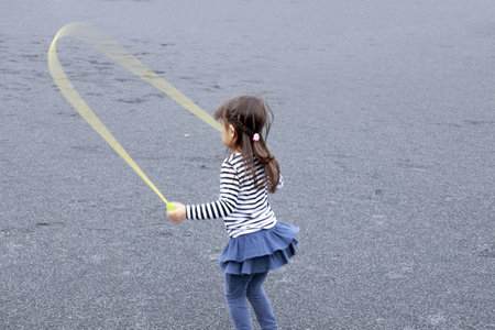 Japanese girl (5 years old) playing with jump ropeの写真素材