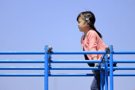 Japanese girl on the jungle gym (5 years old)の写真素材
