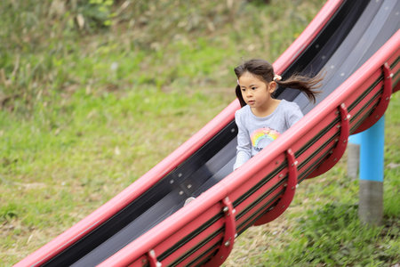 Japanese girl on the slide (5 years old)の写真素材