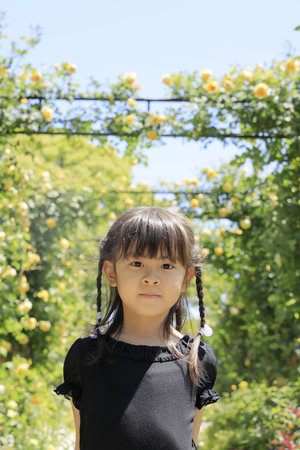 Japanese student girl in rose corridor of Harbor View Park, Yokohama, Kanagawa, Japan (6 years old)