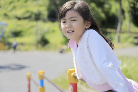Japanese student girl playing with high bar (6 years old)