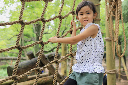 Japanese student girl playing with rope walking (6 years old)の写真素材