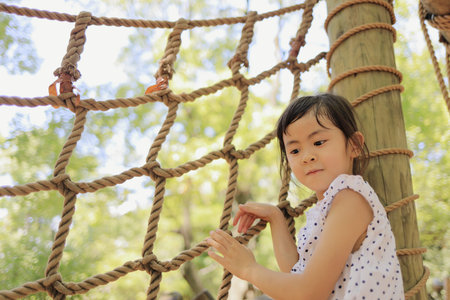 Japanese student girl playing with rope walking (6 years old)の写真素材