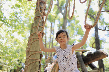 Japanese student girl playing with rope walking (6 years old)の写真素材