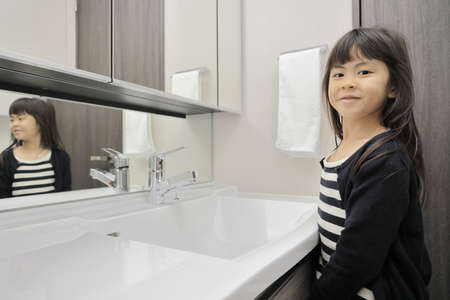Japanese girl washing hands (7 years old)の写真素材