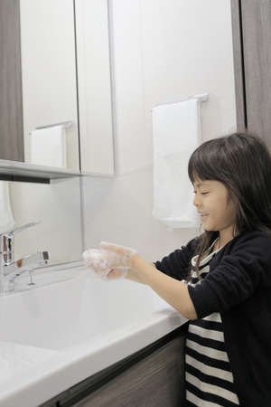 Japanese girl washing hands (7 years old)の写真素材