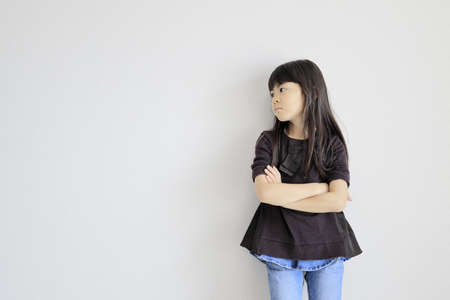 Japanese girl folding her arms (profile) (7 years old)の写真素材