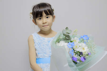Japanese girl in a dress with bouquet (7 years old)の写真素材